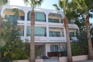 a building with palm trees in front of it at Marianna Hotel Apartments in Limassol
