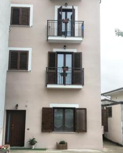 an apartment building with balconies and windows at Butterfly B&B in San Lorenzo