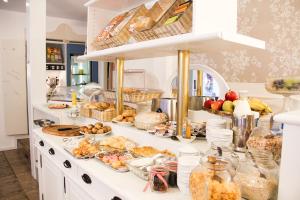 a buffet with many different types of food on a counter at Hotel Café Schlack in Tuttlingen