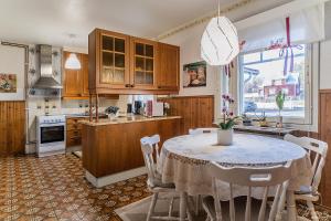 a kitchen with a table and chairs in a kitchen at Westbay Inn in Vaasa