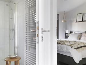 a white bedroom with a bed and a shower at Chalet in Zell am See near Ski Slope in Markelo +32 photos
