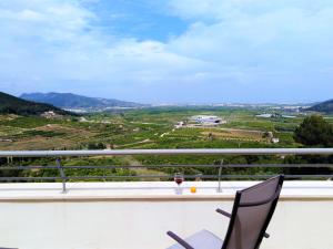 a view from the balcony of a house with a glass of wine at Monte Corona in Ador