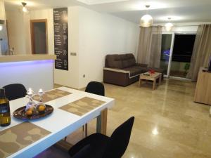 a living room with a table and chairs and a couch at Monte Corona in Ador +17 photos