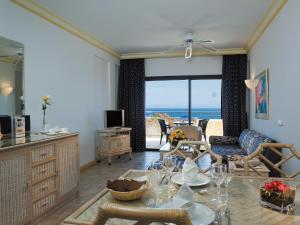 a living room with a view of the ocean at Apartamentos BlueBay Beach Club in San Agustin