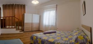 a bedroom with a bed and a dresser at Apartman Aurora in Poreč