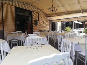 a banquet hall with white tables and white chairs at Residenza Gargano in Tropea