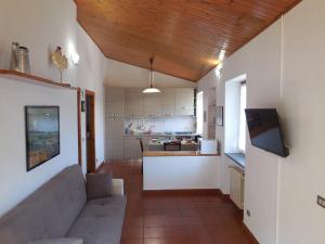 a living room with a couch and a kitchen at vignale holiday house in La Spezia