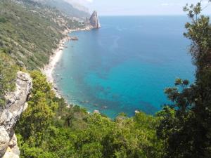 a view of a beach from a cliff at Il Giardino in Baunei