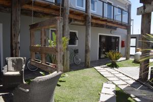 a yard with chairs and a house with a bike at Driftwood Guesthouse in Swakopmund