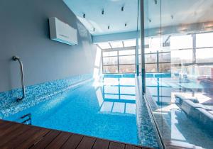 a swimming pool with a hammock in a building at Młyńska 8 Apartament z prywatnym basenem in Bielsko-Biała