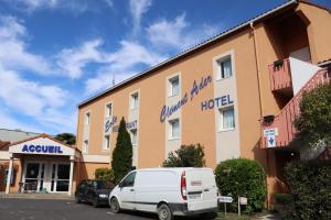 a hotel with a white van parked in front of it at Hôtel Restaurant Clément ADER in Muret