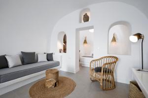 a living room with a couch and a chair at Virginia's Cave Villas in Oia