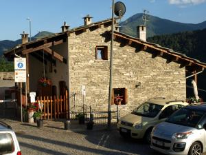 a stone building with cars parked in front of it at B.&.B 44 in Ostana