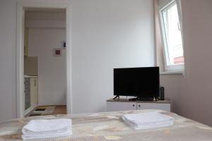 a bedroom with a bed with two towels on it at Apartman Studio 2 in Brčko