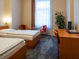 Ένα ή περισσότερα κρεβάτια σε δωμάτιο στο Hotel Olympia Česká Lípa