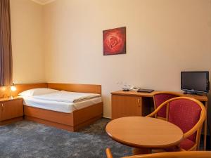 Ένα ή περισσότερα κρεβάτια σε δωμάτιο στο Hotel Olympia Česká Lípa