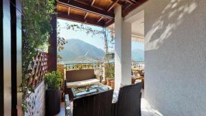 a balcony with chairs and a view of a mountain at Apartment Stella di Cattaro in Kotor