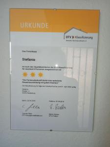 a piece of paper on a wall with a diploma at Haus Stefanie in Niederburg