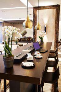a dining room table with a laptop on top of it at Steigenberger Hotel Köln in Cologne