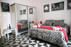 a bedroom with a zebra print bed and a mirror at Pitagora House in Taranto +42 photos