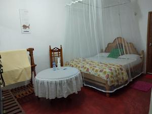 a bedroom with two twin beds and a table at Homeaway Homestay Hatton in Hatton