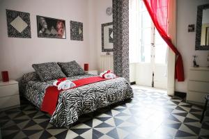 a bedroom with a bed with two stuffed animals on it at Pitagora House in Taranto