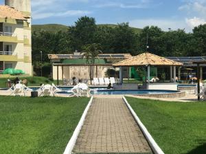 a resort with a swimming pool and a building at Aldeia das Águas Barrakana flats in Nossa Senhora das Dores