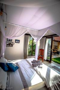 Ein Bett oder Betten in einem Zimmer der Unterkunft Villa Impian