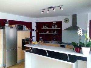 a kitchen with a stainless steel refrigerator and a stove at Fewo Floss in Floß