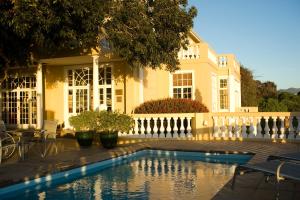 a house with a swimming pool in front of a house at Colona Castle in Lakeside