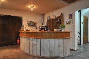a bar with a wooden counter in a room at El Greco in Igoumenitsa