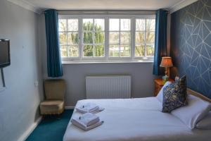 A bed or beds in a room at Llanerch Inn