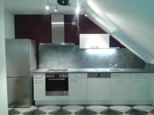 a kitchen with a sink and a refrigerator at Ferienwohnung Ludwig mit Balkon in Karlstadt
