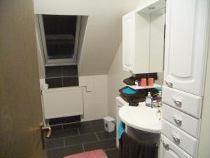 a small bathroom with a sink and a mirror at Ferienwohnung Ludwig in Karlstadt