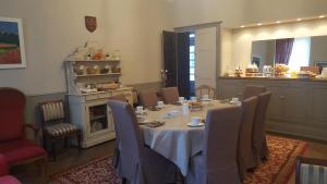 La Belle Vie B&B في مورْيال: غرفة طعام مع طاولة مع كراسي ومدفأة
