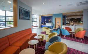a waiting room with a couch and chairs at Travelodge Plus Galway in Galway