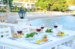 a table with plates of food and wine glasses at Marvel Tree Hotel in Bozyazı