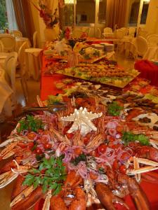una mesa llena de diferentes tipos de marisco y verduras en Hotel Astra, en Milano Marittima