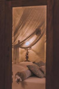 a bedroom with a bed with a canopy and a lamp at La Casa Di Nonna in Koríthion