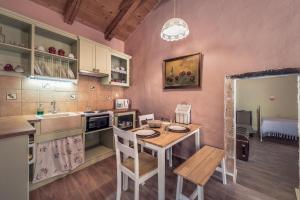 a kitchen with a table and a sink and a counter at La Casa Di Nonna in Koríthion