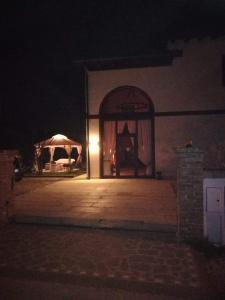 a night scene of a building with a tent at Casa Degli Amici in Treviso