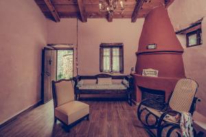 a living room with a couch and a chair at La Casa Di Nonna in Koríthion