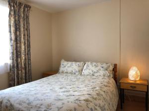 sypialnia z łóżkiem i oknem w obiekcie Lake View Cottage w mieście Flannery Bridge