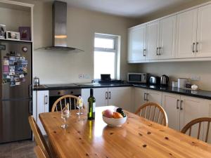 a kitchen with a wooden table with a bowl of fruit at Lake View Cottage in Flannery Bridge