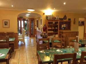 a restaurant with tables and chairs in a room at BORD DE L’EAU APARTMENT in Wick