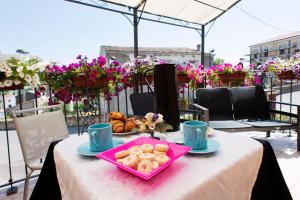 un tavolo con un vassoio rosa di dolci sopra di La Casa Dei Fiori a Montecilfone