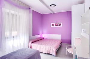A bed or beds in a room at La Casa Dei Fiori