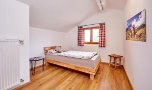 een kleine slaapkamer met een bed en een raam bij Ferienwohnung zum Servus in Garmisch-Partenkirchen