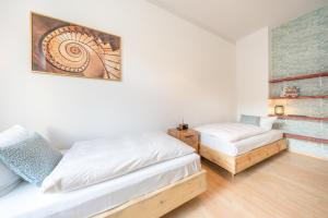 a bedroom with two beds and a couch at Design Apartments - "Am Schloss" in Potsdam