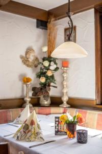 a table with a white table cloth and a lamp at Hotel Rössle in Freiberg am Neckar